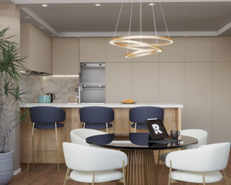 Modern kitchen island with bar stools and dining area.
