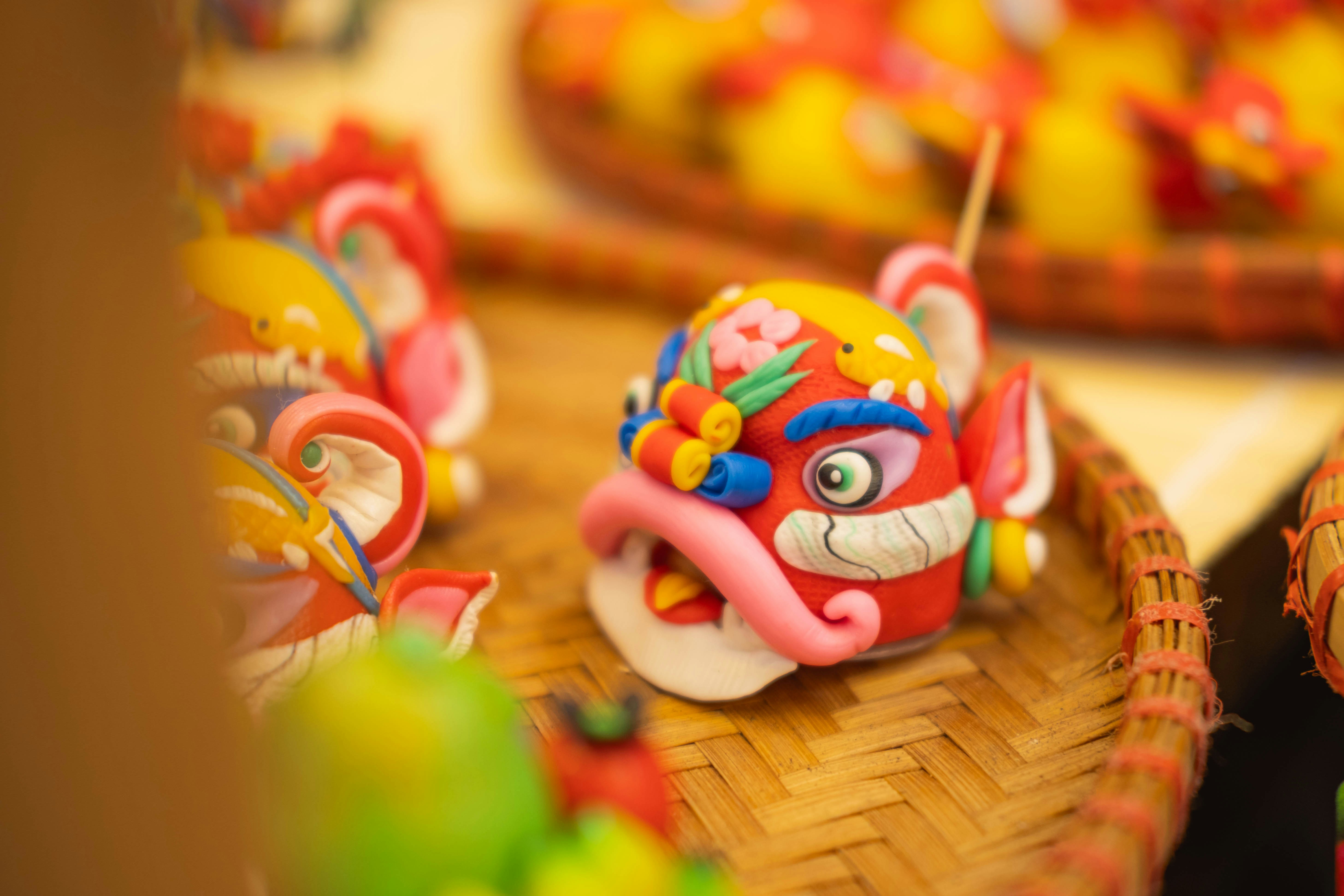 Colorful dough sculptures of lion heads and other figures.