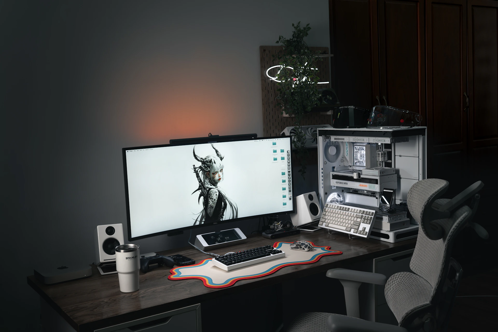 Modern computer setup with large monitor and gaming chair.