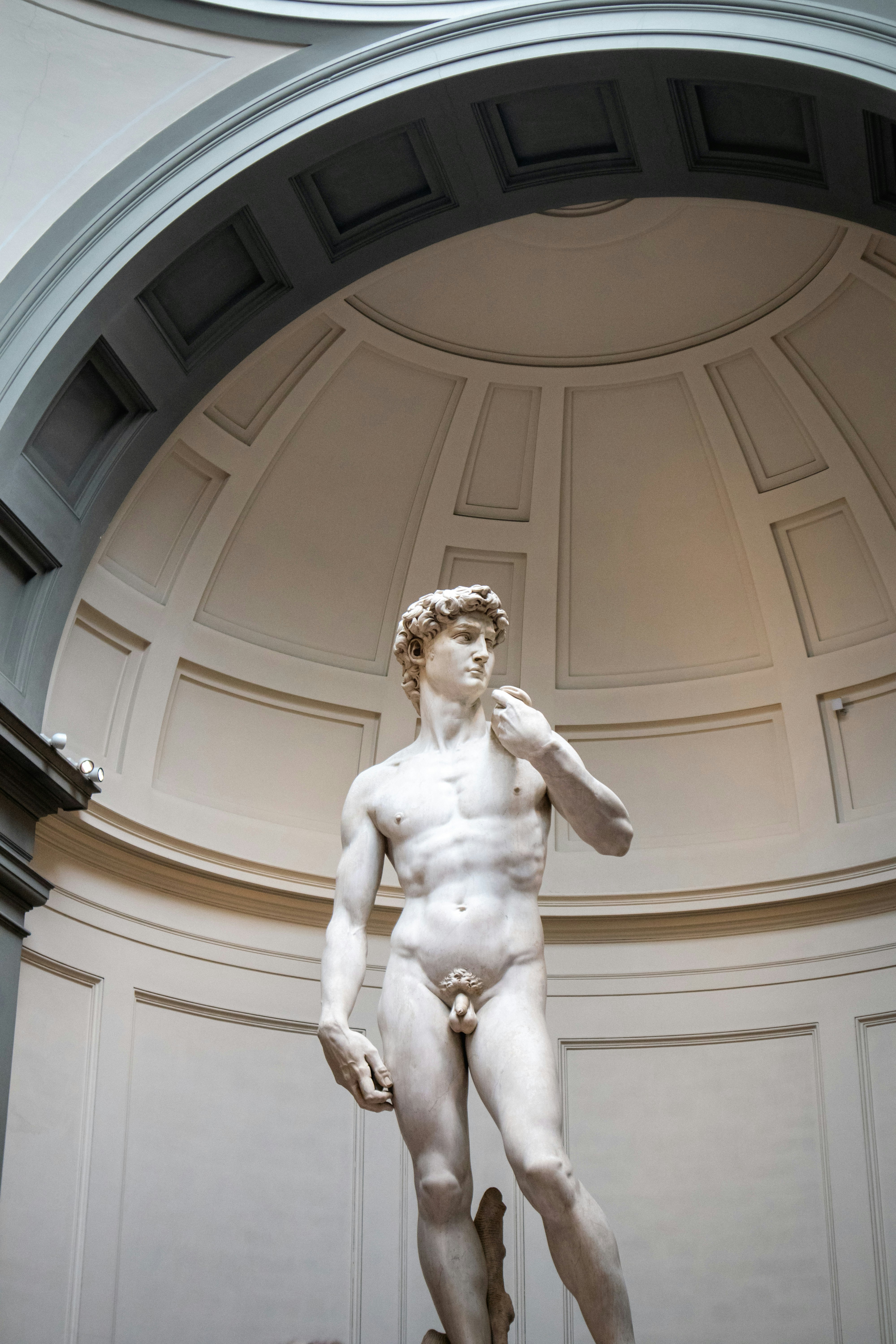 Michelangelo's david statue in a museum interior.