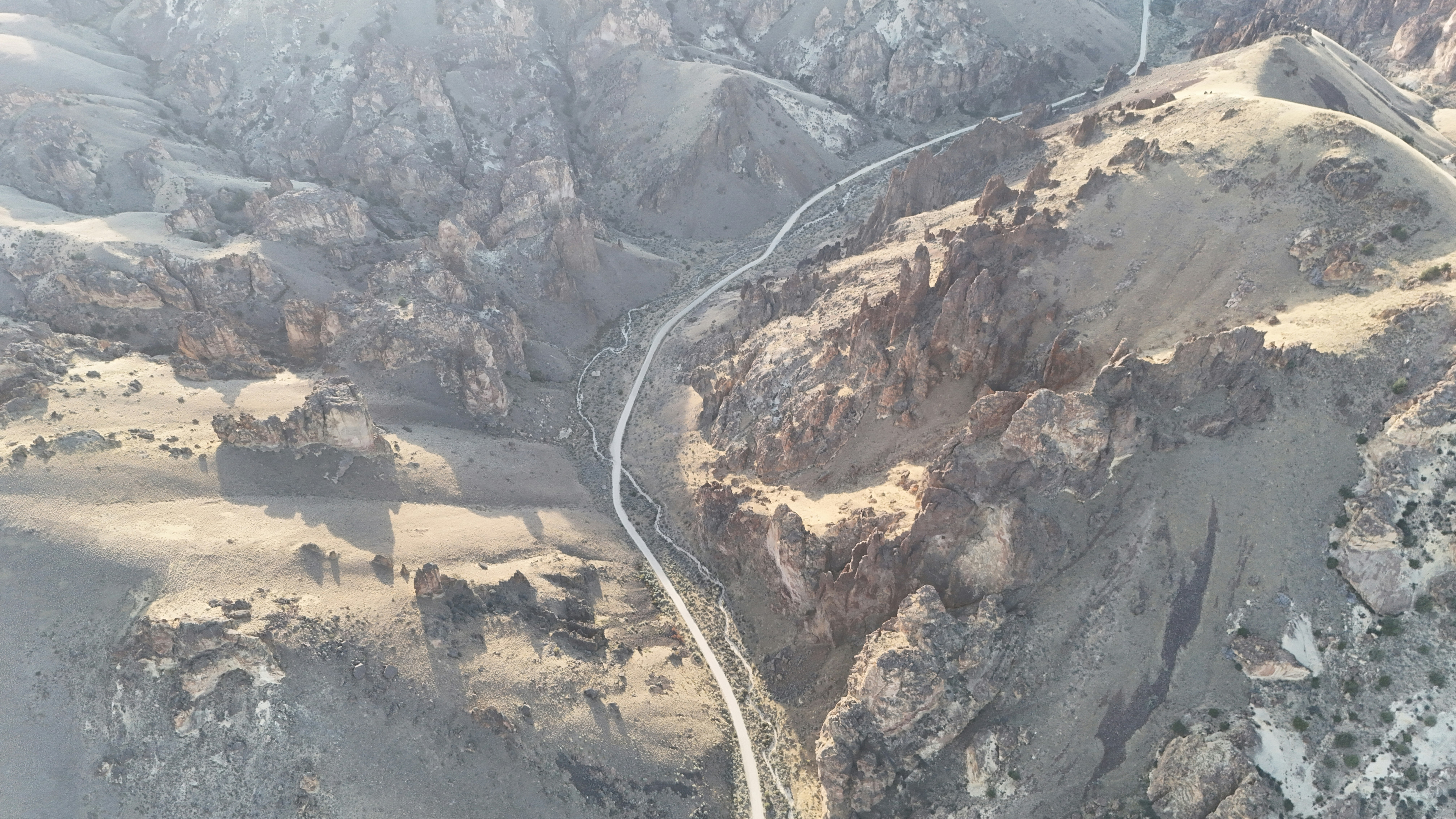 Aerial view of a winding road through arid mountains