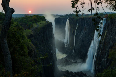 Victoria Falls at sunrise, spray rising from the gorge