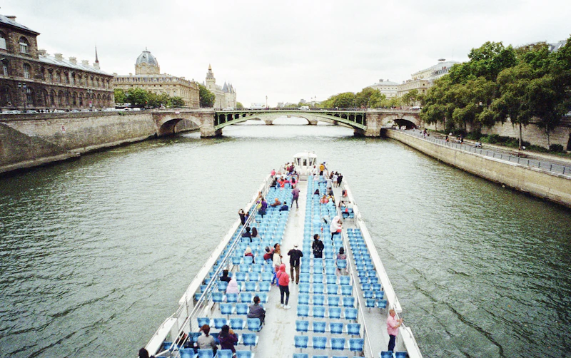 A boat gliding along the Seine in Paris in soft evening light