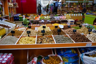 Assortment of dried fruits and nuts at a market stall.
