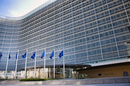 Modern glass building with european union flags
