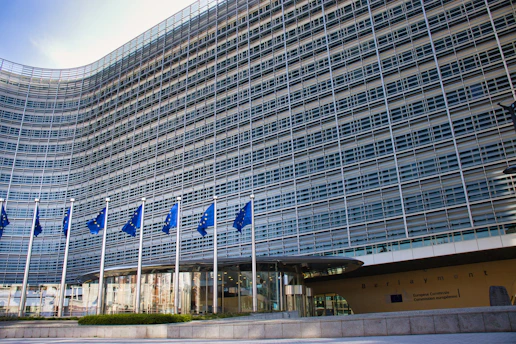 Modern glass building with european union flags