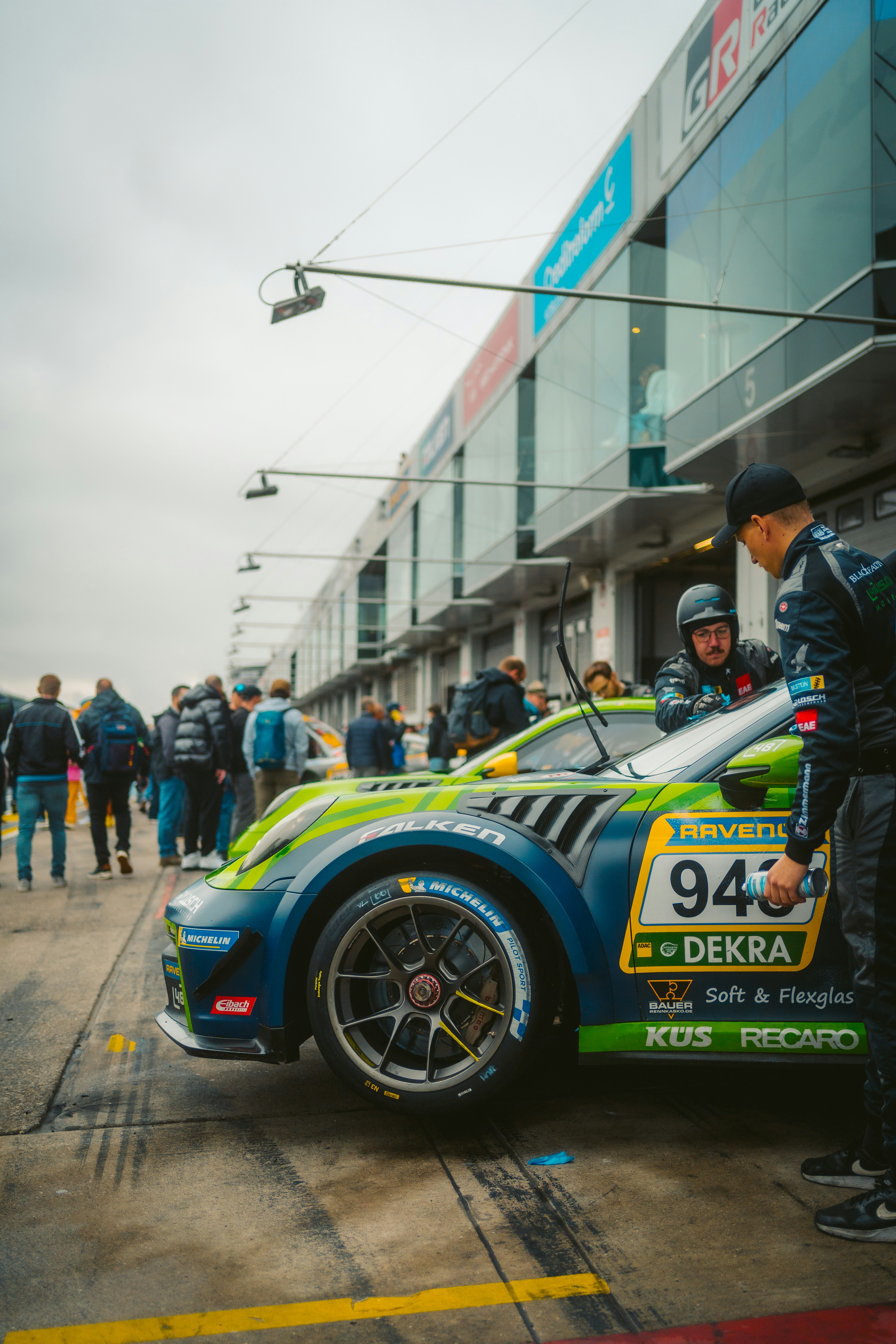 Race car with crew in pit lane during event