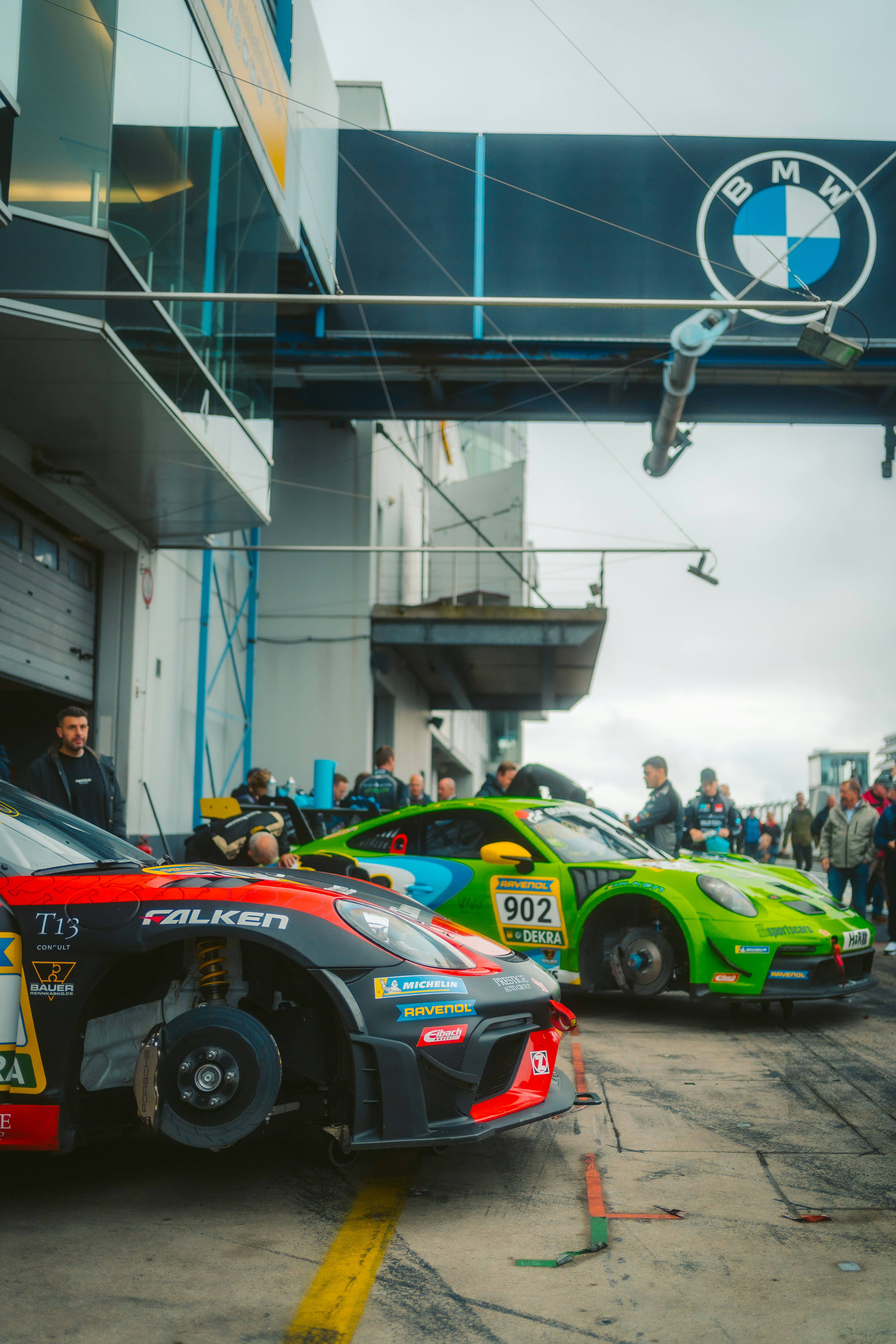 Race cars in pit lane with BMW logo overhead photo – Free Sports car ...