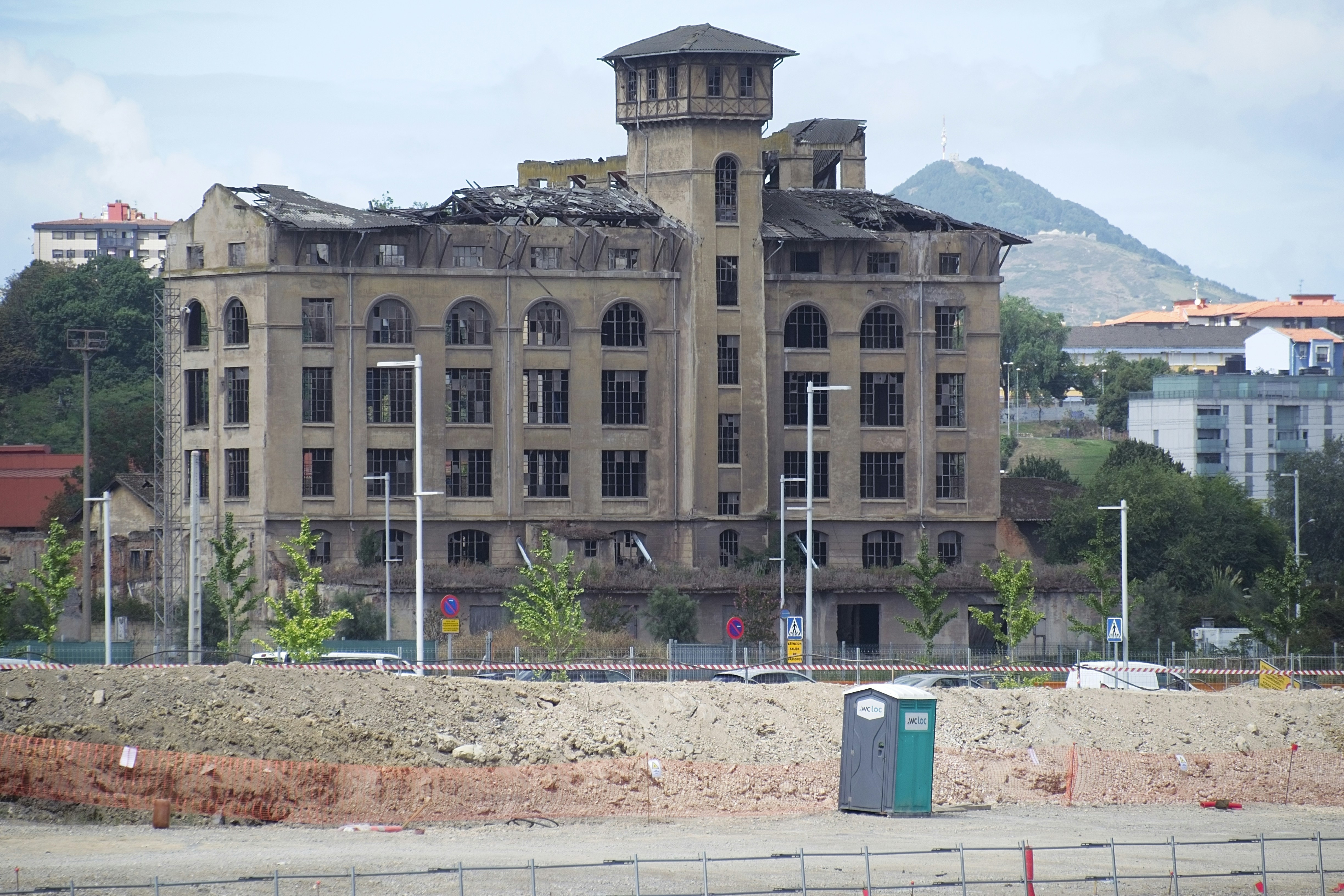 A roof with visible damage from a storm, with some shingles missing.