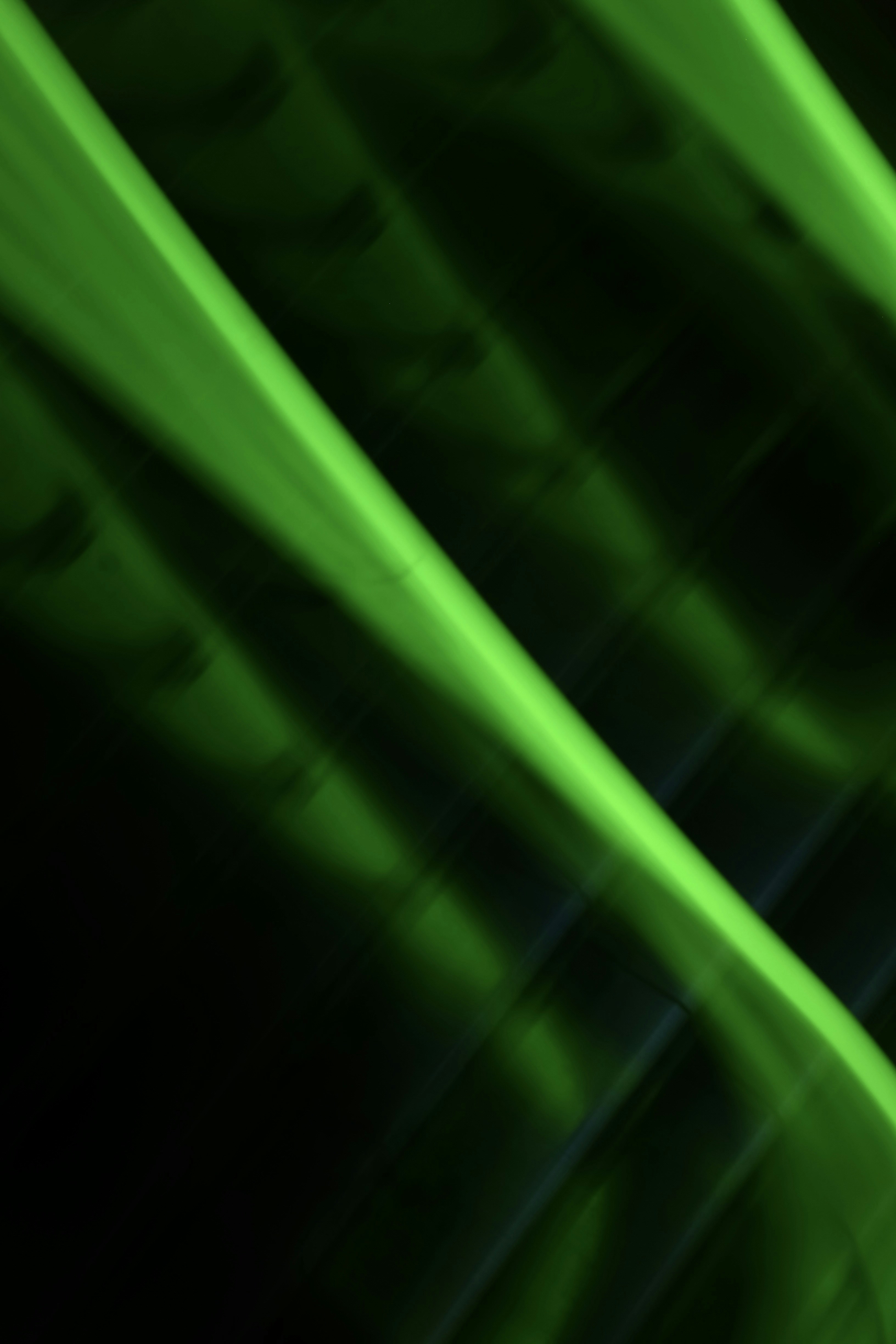 Abstract green light streaks on dark background