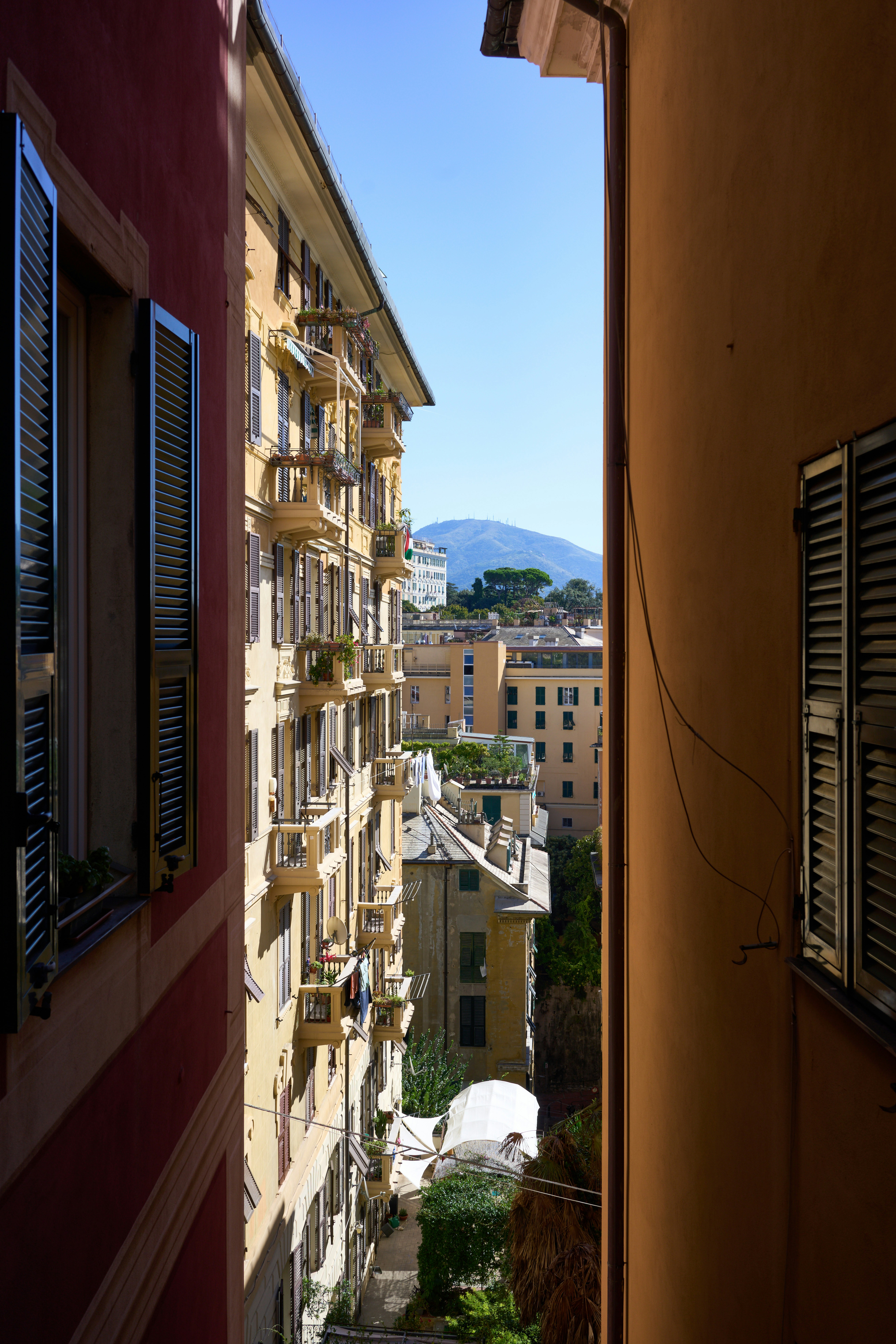 Narrow alley between buildings with distant mountain view
