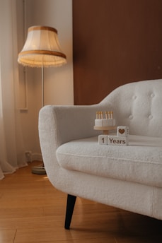 White couch with birthday cake and '1 years' blocks.