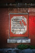 Quote about justice on a brick wall.