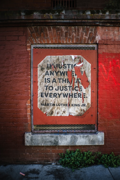 Quote about justice on a brick wall.