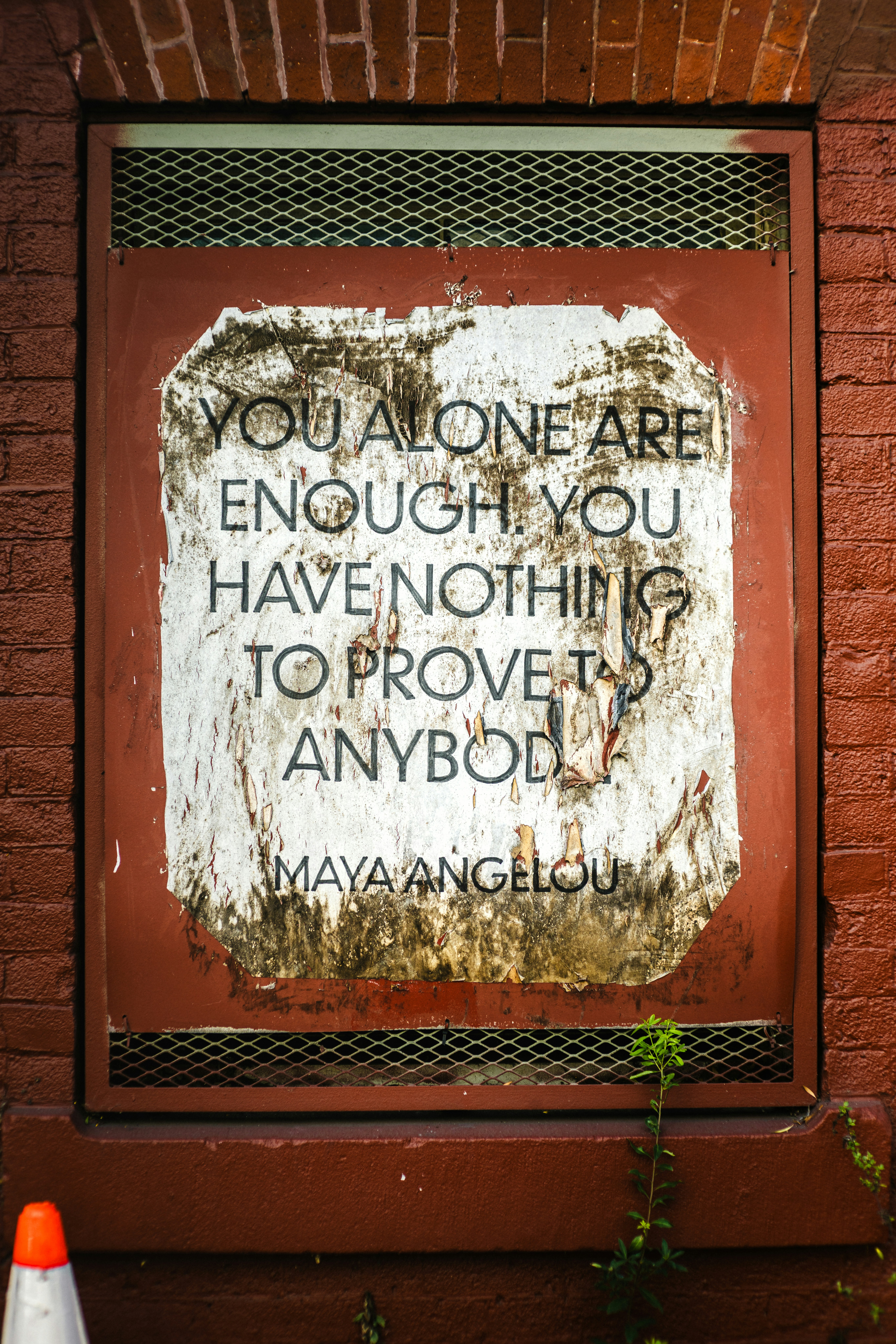 Quote by maya angelou on a weathered poster.
