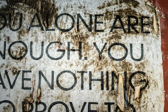 Torn poster with text about self-worth.