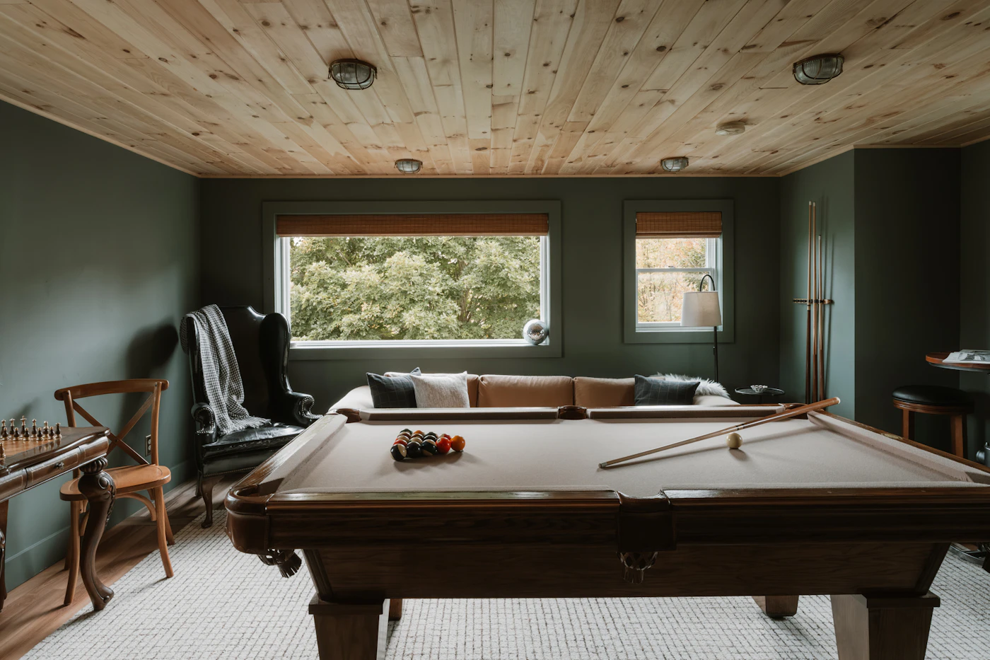 Basement rec room with pool table and wood ceiling