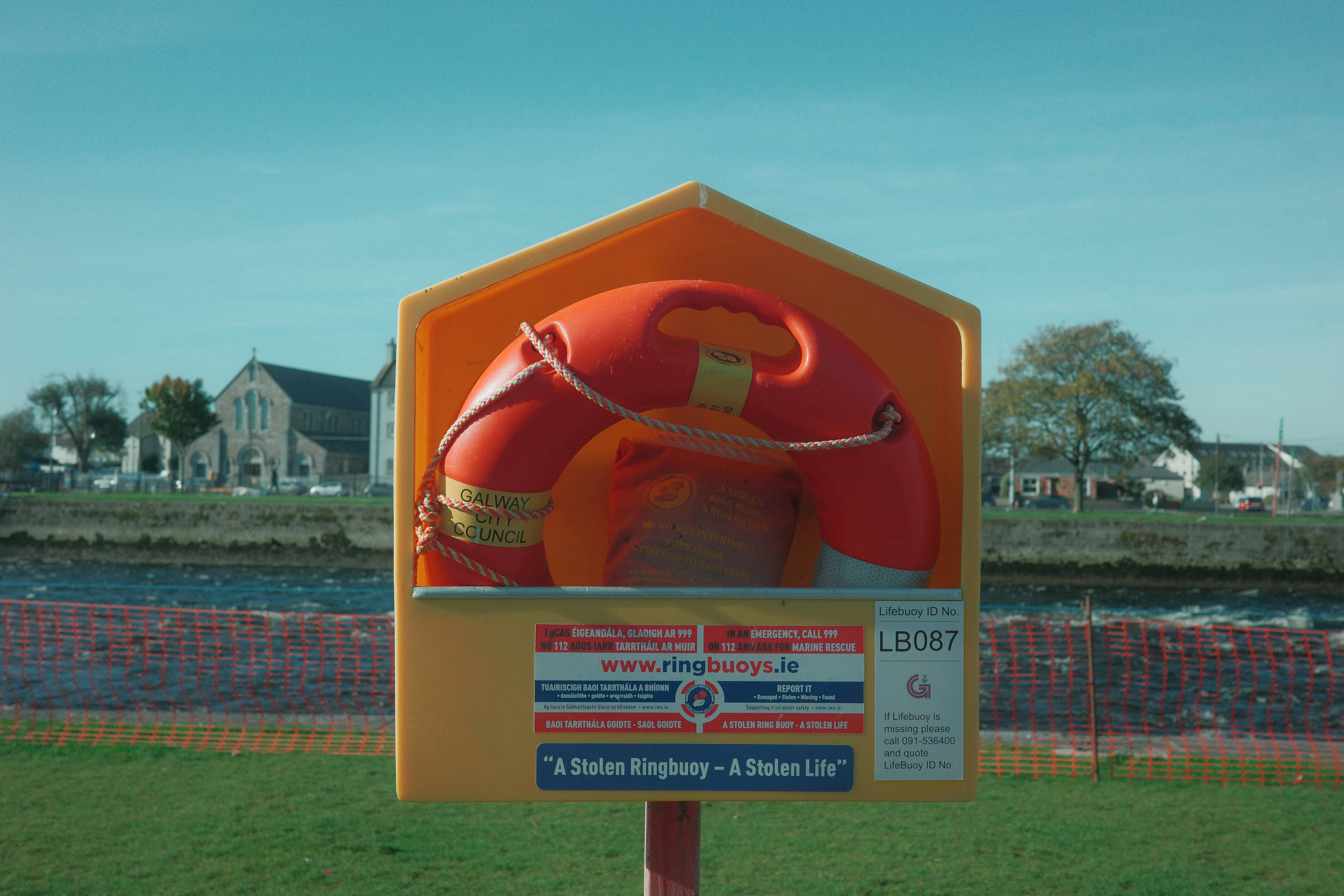 Orange life preserver in a yellow safety station.