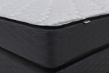 Close-up of a modern mattress with a dark patterned base.