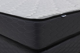 Close-up of a modern mattress with a dark patterned base.
