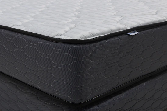 Close-up of a modern mattress with a dark patterned base