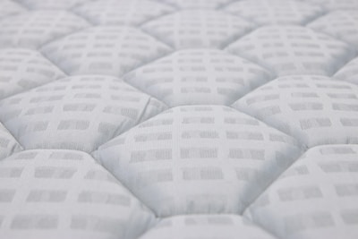 Close-up of a white quilted mattress texture