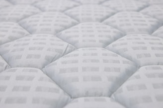 Close-up of a white quilted mattress texture