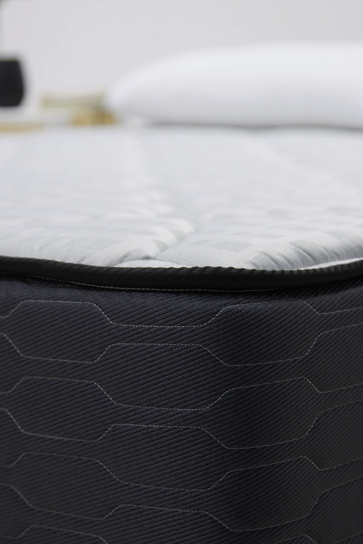 Close view of a mattress surface, mattress pad, and pillow