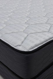 Close-up of a quilted mattress with dark sides.