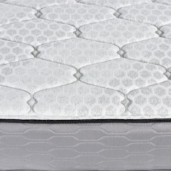 Close-up of a quilted mattress surface with hexagonal pattern