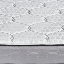 Close-up of a quilted mattress surface with hexagonal pattern