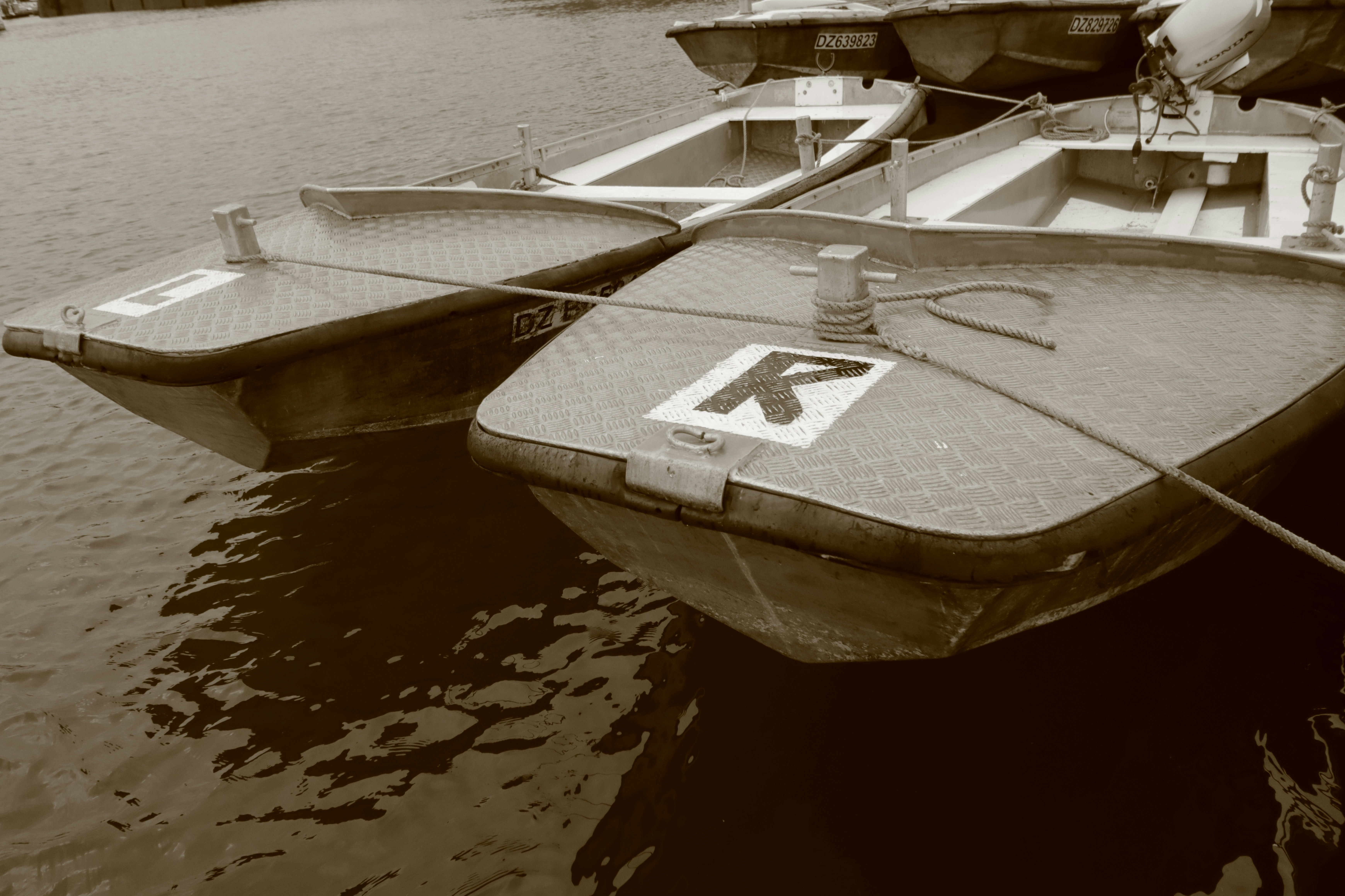 Several small boats tied together on water