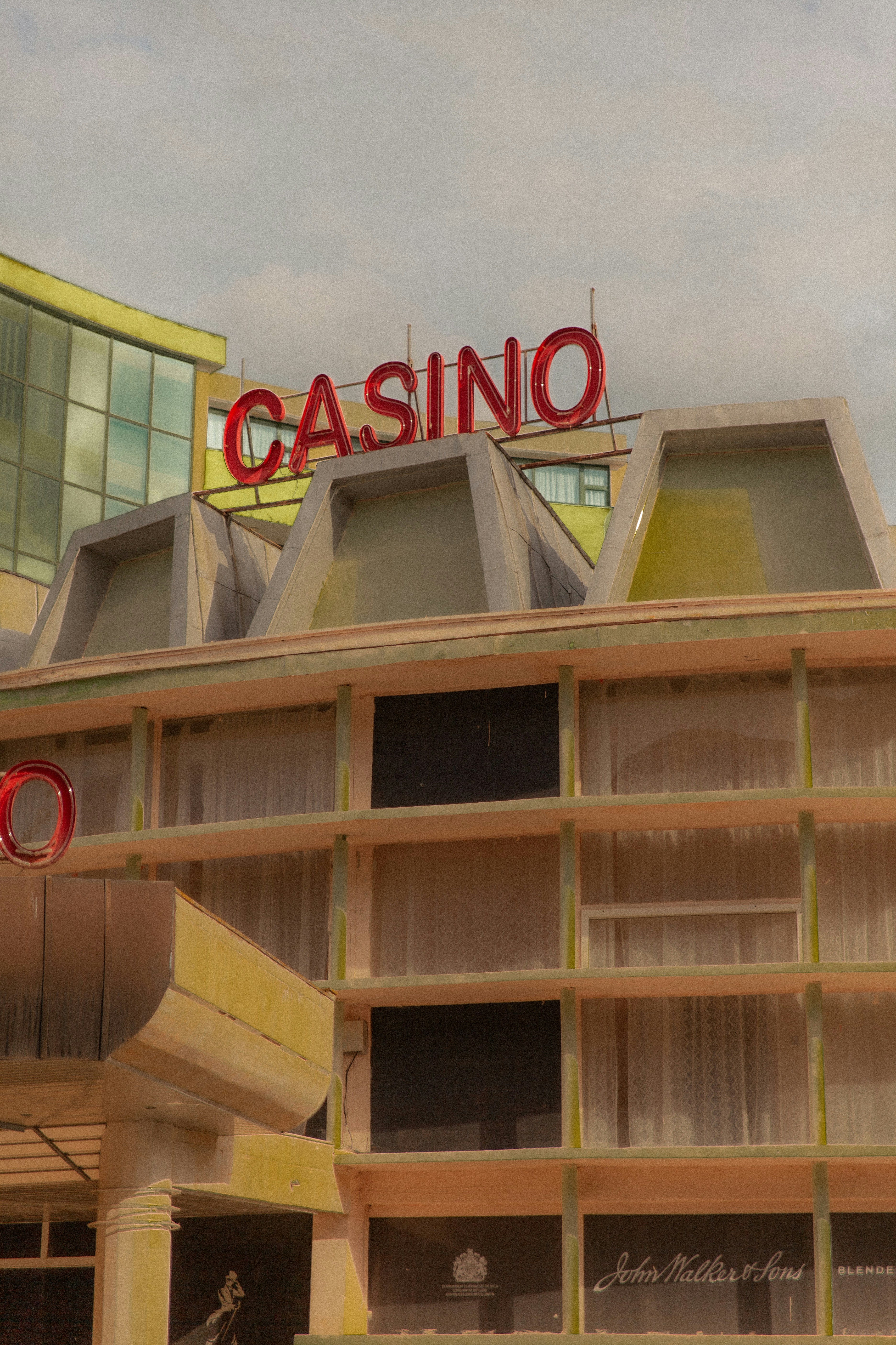 Casino building with neon sign under cloudy sky