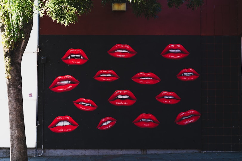 Red lips mural on a dark wall
