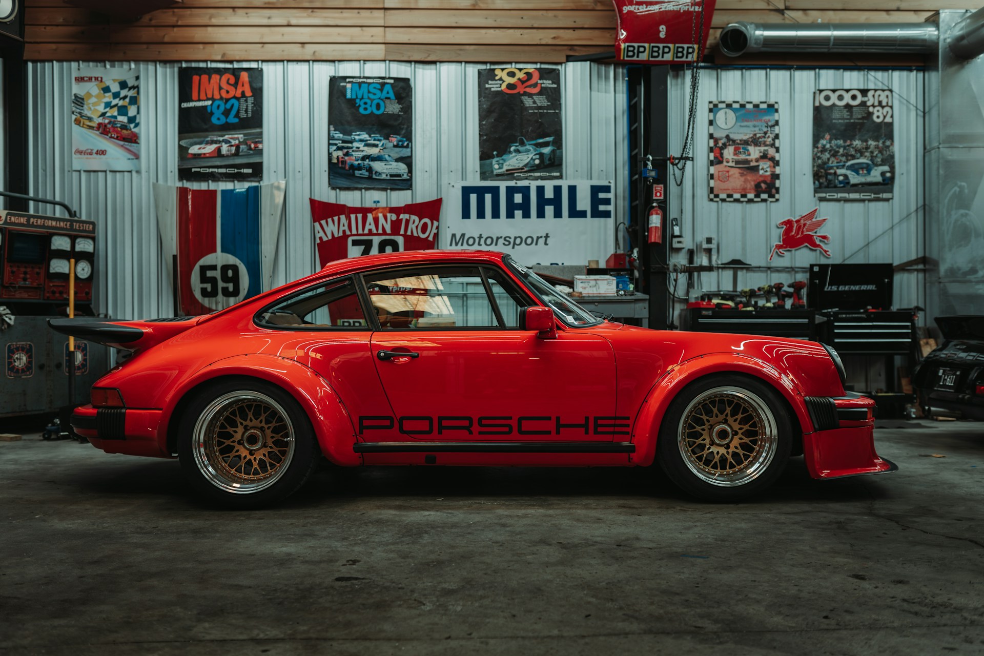 Red porsche sports car parked in a garage