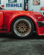 Red sports car wheel with gold bbs rims