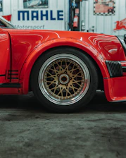 Red sports car wheel with gold bbs rims