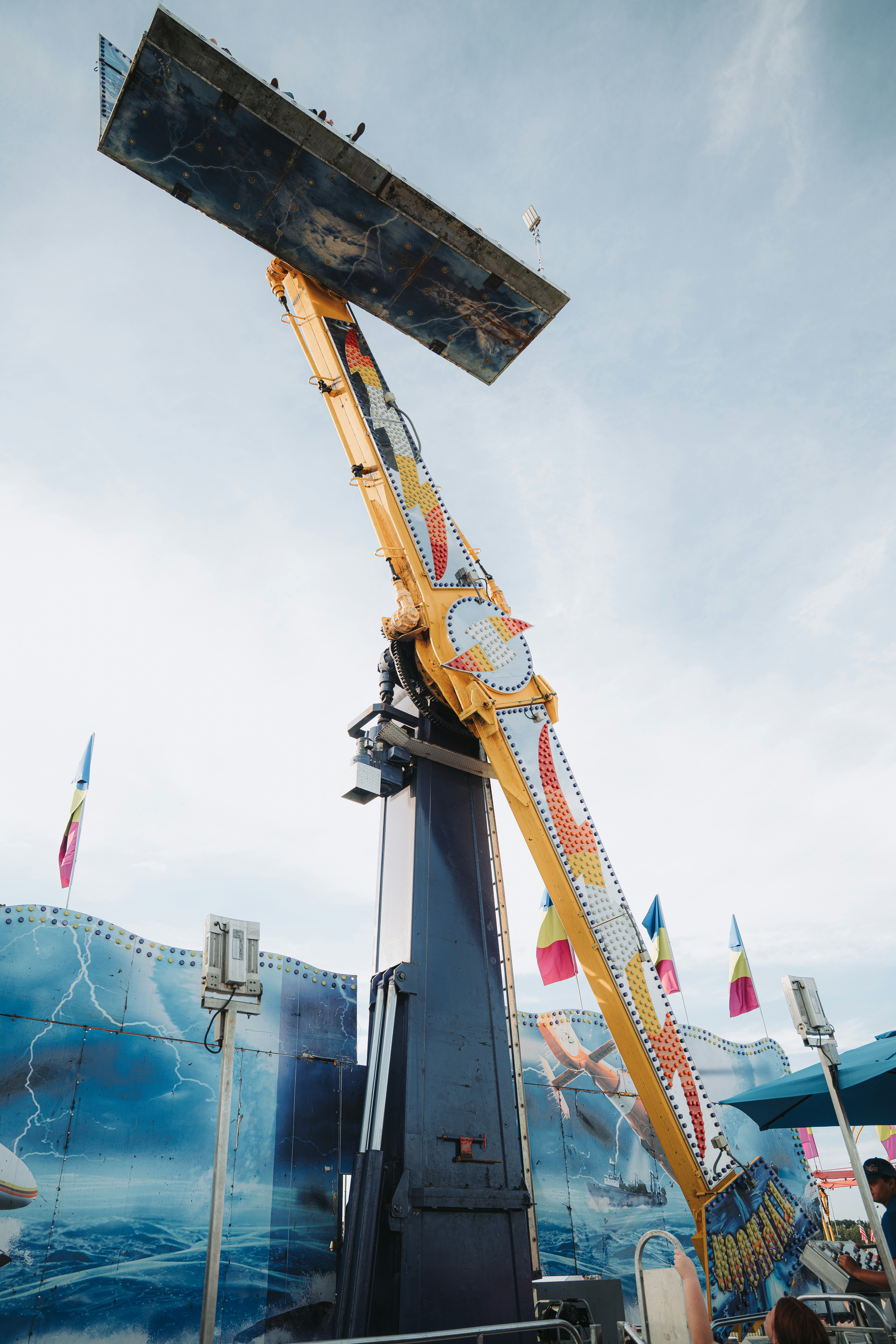 Amusement park ride swings people high in the air.
