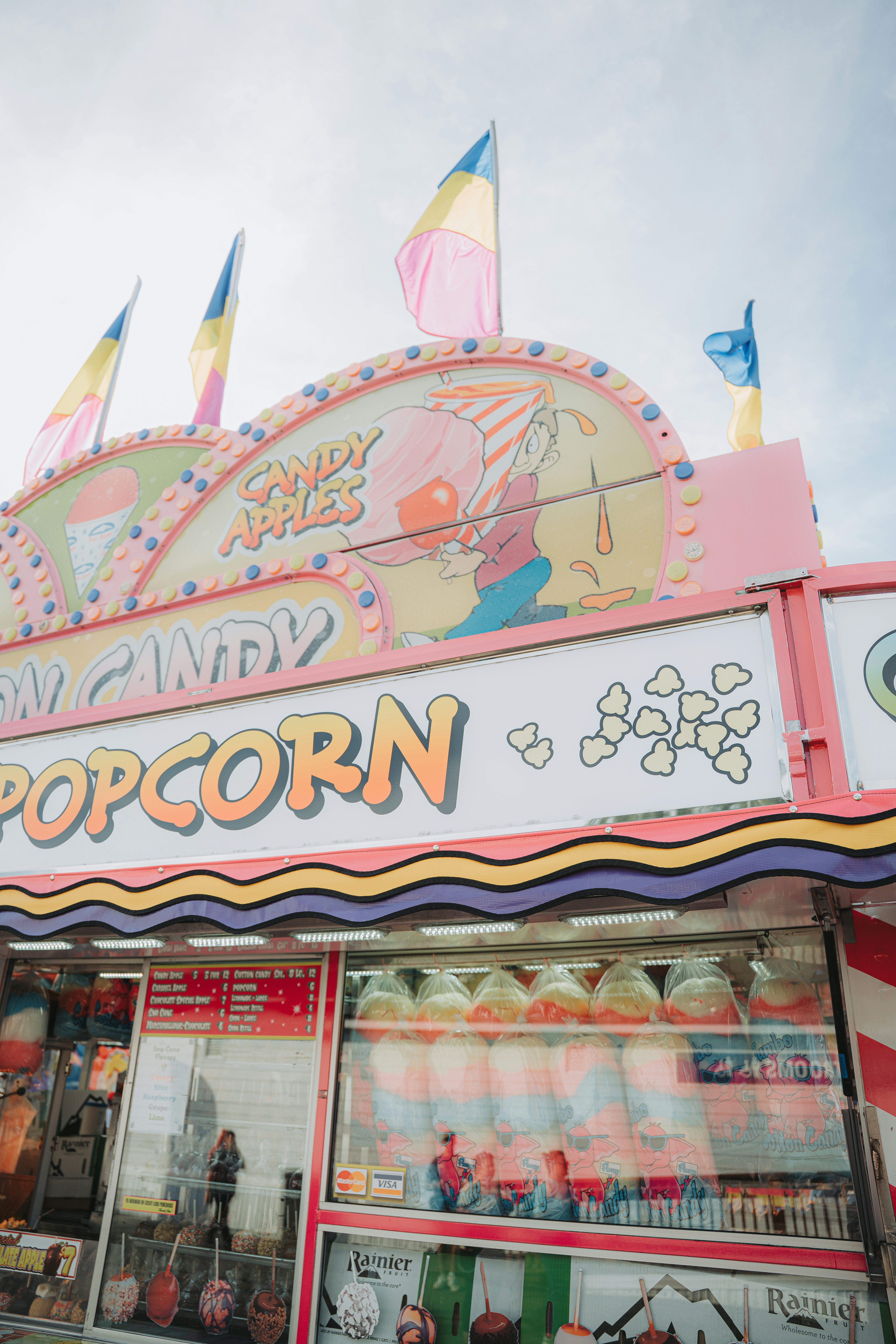 Candy apples and popcorn stand at a fair.