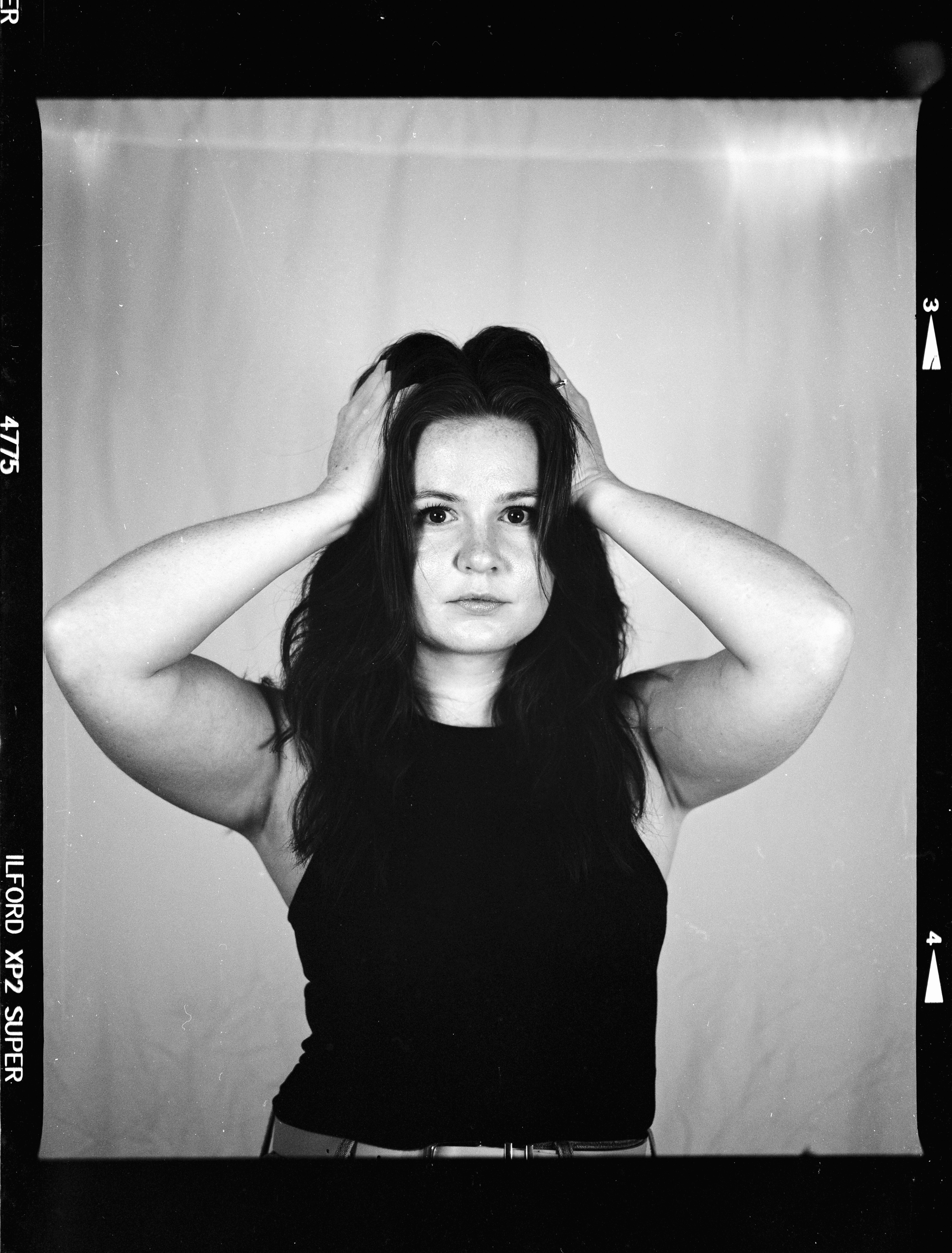 Young woman with hands in her dark hair