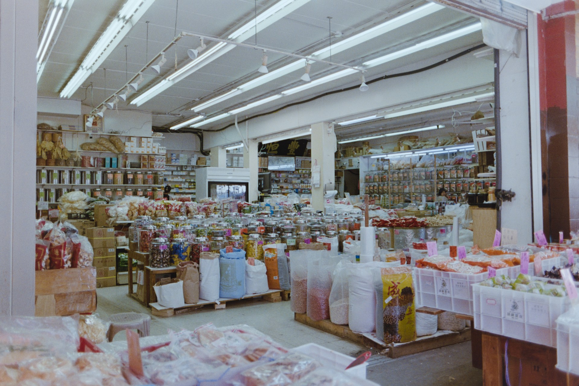 Interior of a well-stocked grocery store with aisles of goods.
