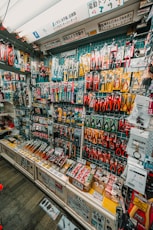 Wall display of assorted tools and hardware in a store.