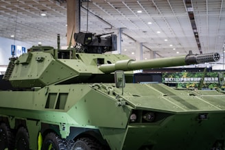 A green armored military vehicle with a large cannon.