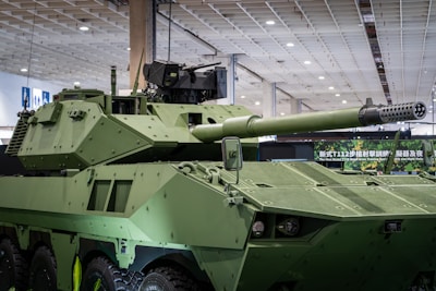A green armored military vehicle with a large cannon.