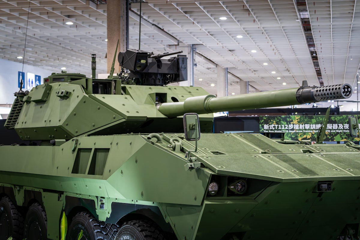 A green armoured military vehicle with a large cannon