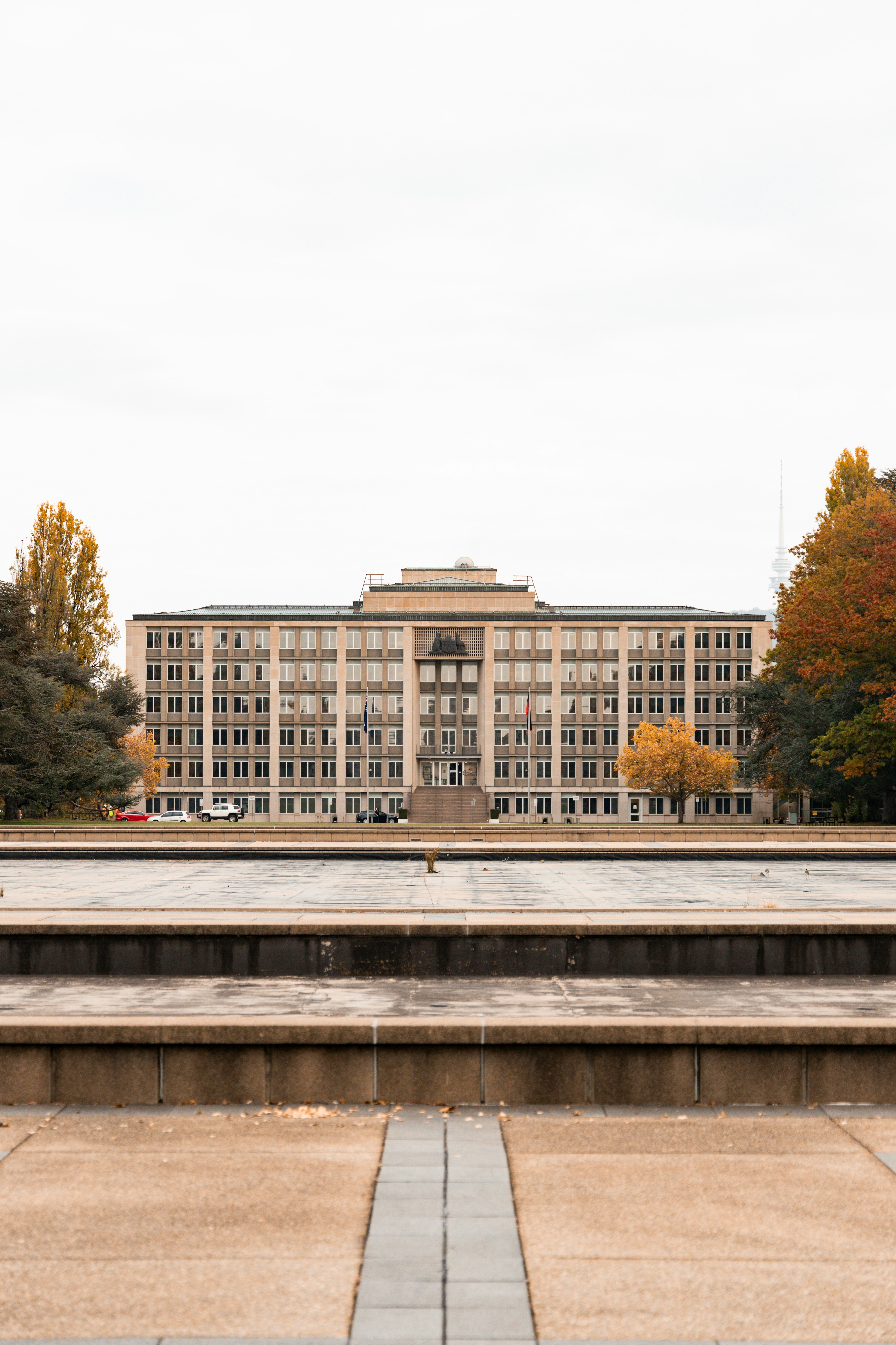 Large building with autumn trees and fountain