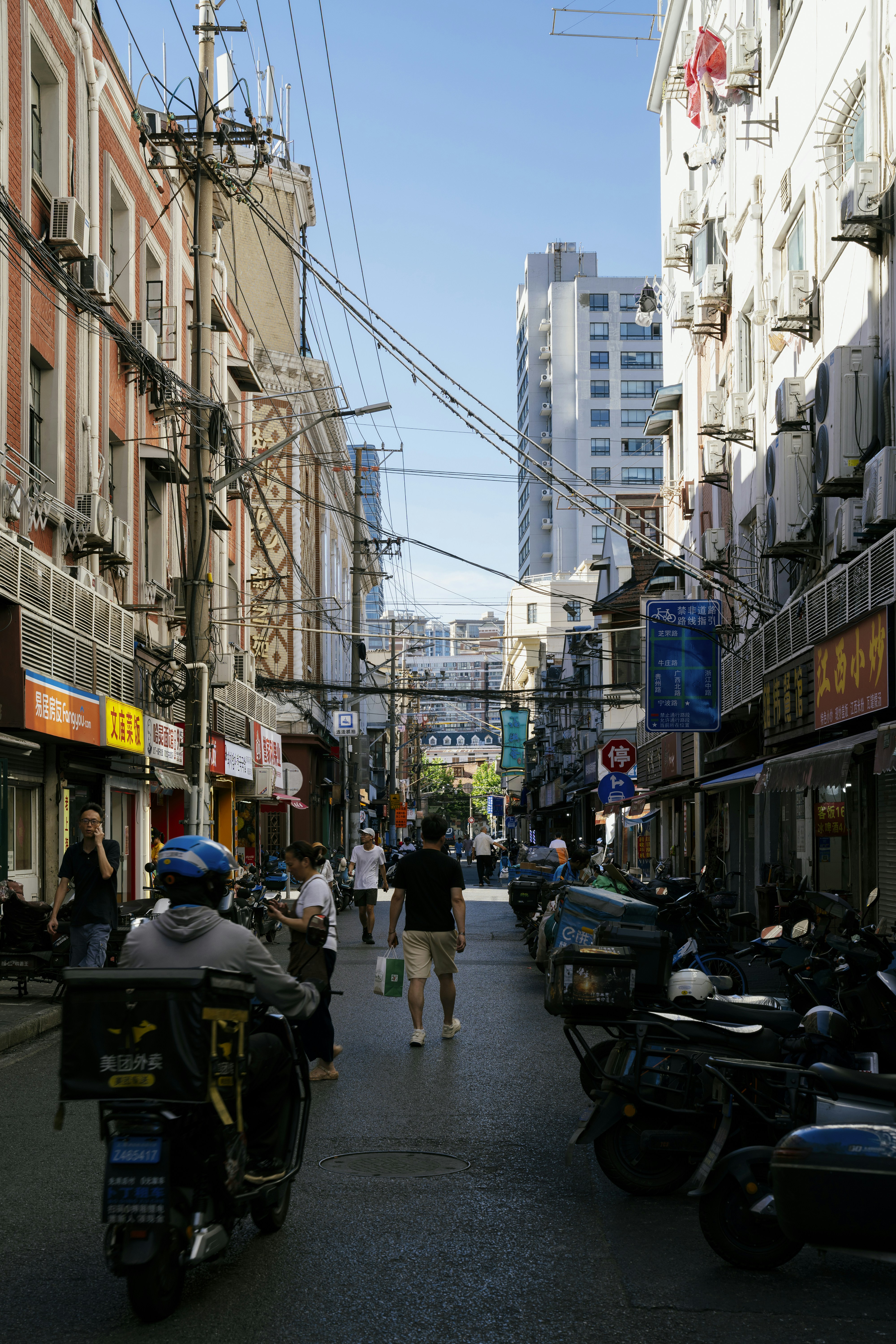 Street scene with motorcycles and buildings under blue sky
