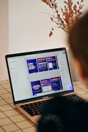Person looking at a laptop screen with presentation slides.