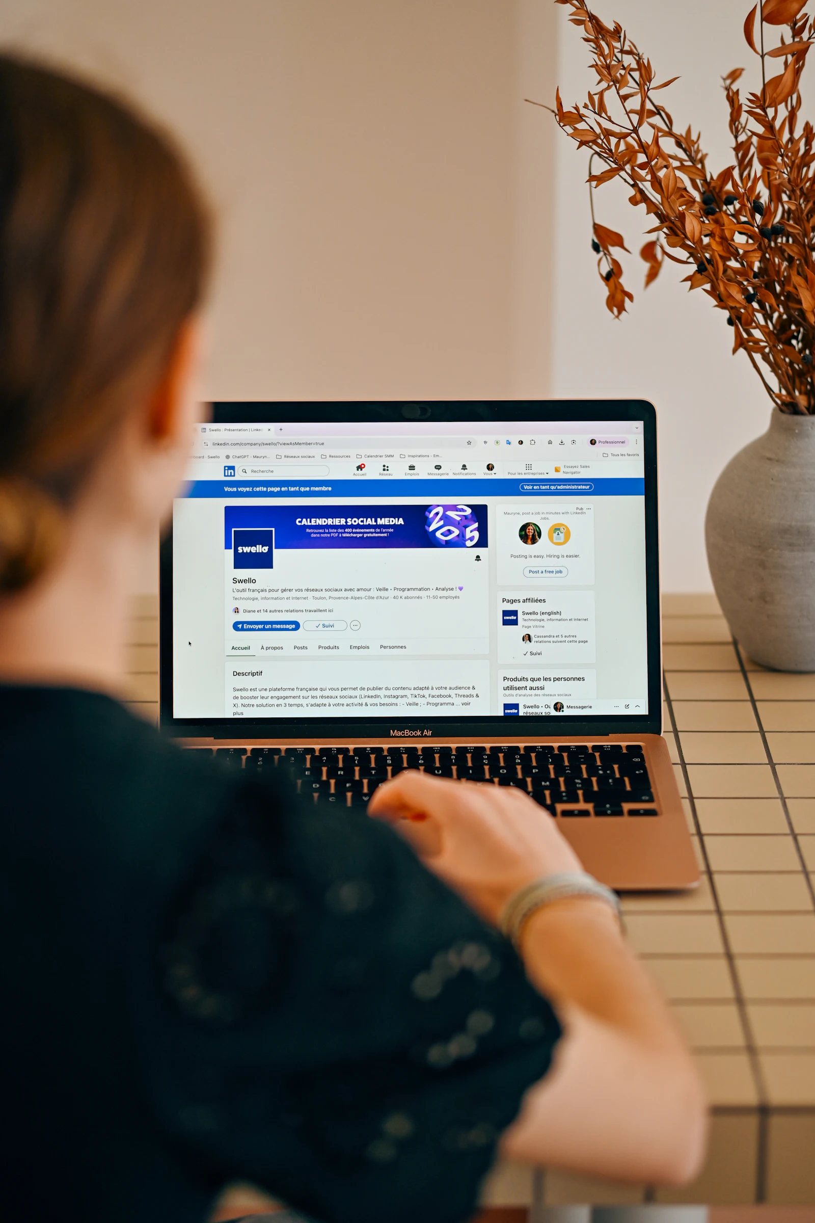 A social media manager working on a laptop campaign calendar