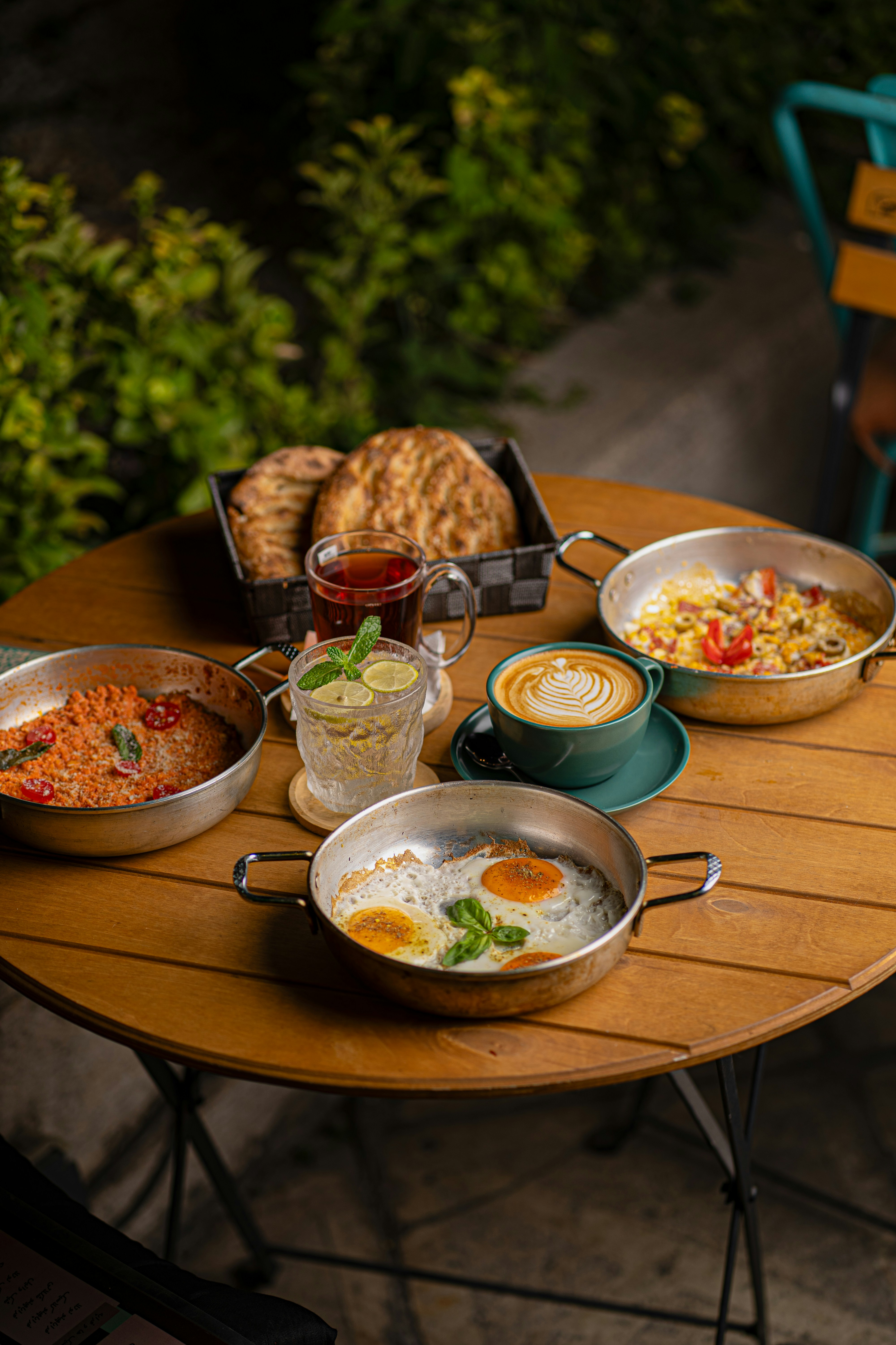 A table laden with breakfast dishes, tea, and coffee.